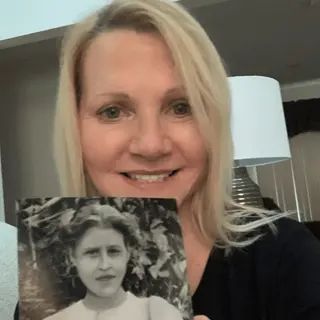A customer holding their restored photo