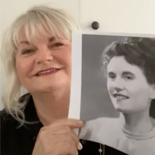 A customer holding their restored photo