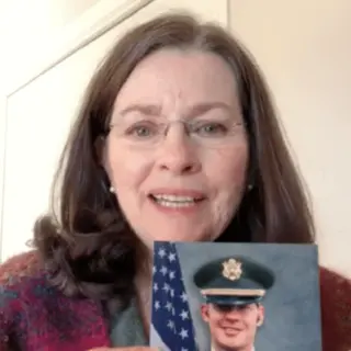 A customer holding their restored photo