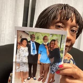 A customer holding their restored photo