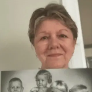 A customer holding their restored photo