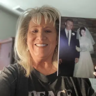 A customer holding their restored photo