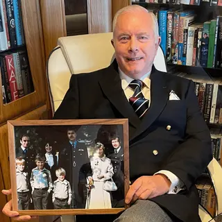 A customer holding their restored photo