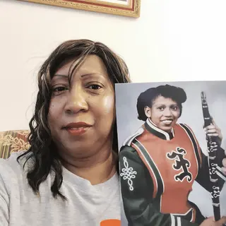 A customer holding their restored photo