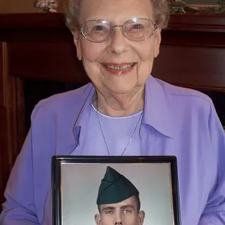 A customer holding their restored photo