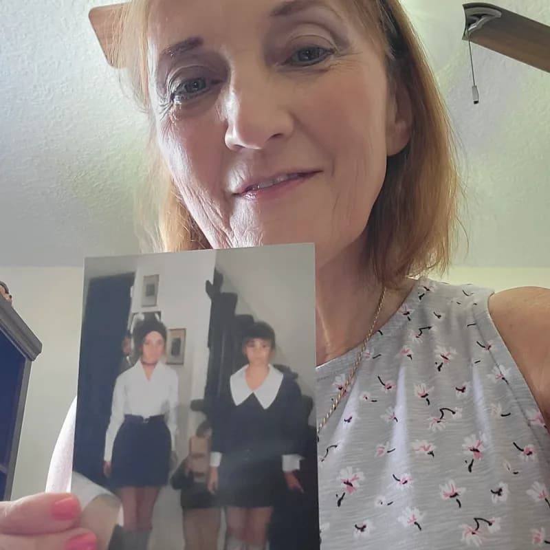 A customer holding their restored photo