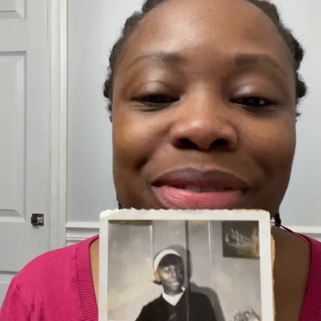 A customer holding their restored photo