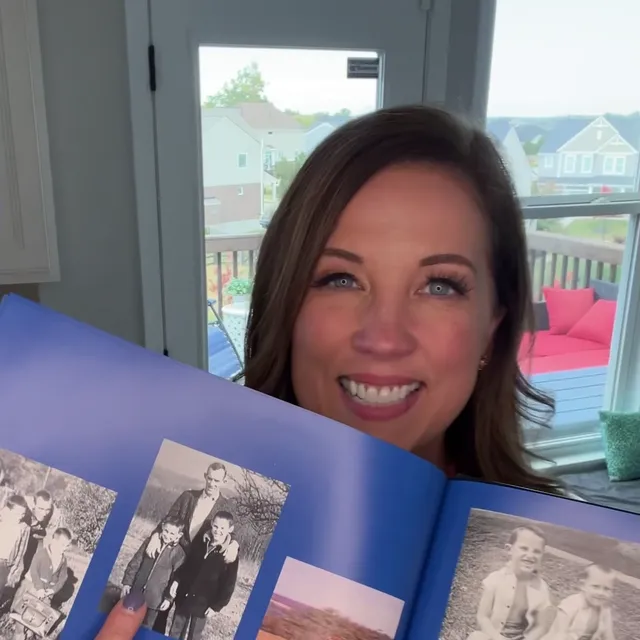 A customer holding their restored photo
