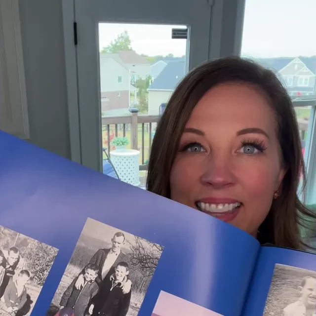 A customer holding their restored photo