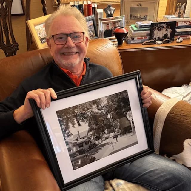 A customer holding their restored photo