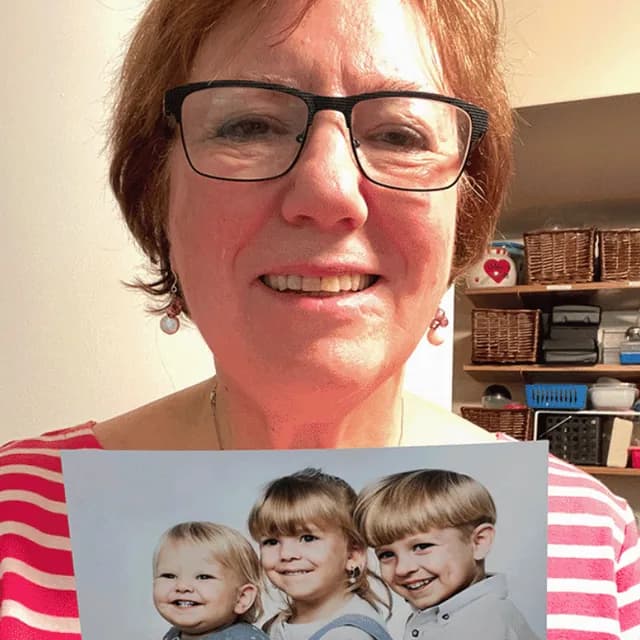 A customer holding their restored photo