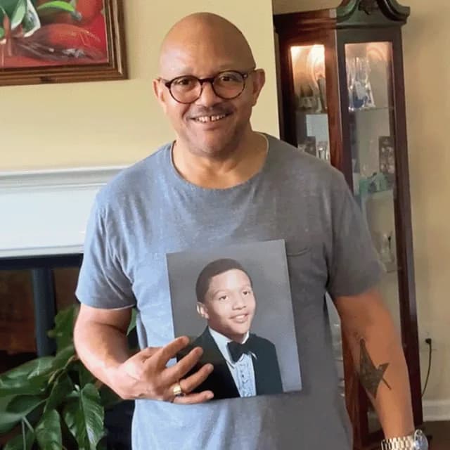 A customer holding their restored photo